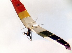 Photo of a 1970s hang glider in flight