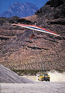 Art based on a photo by Kelvin Jones of Ian Huss of Fly America launching from a desert road via truck tow in 1988