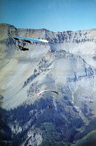 Art based on a photo by Leroy Grannis of a hang glider camera ship and a paraglider at Telluride, Colorado
