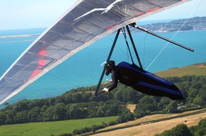 Rob Schwab flying a hang glider at Ringstead in July 2018