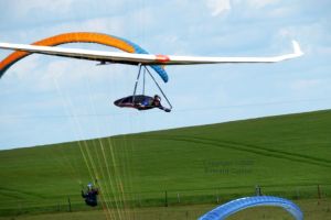 Paragliders and a hang glider flying at Mere, Wiltshire, UK, in June 2020
