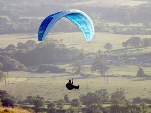 Paraglider in flight at Bell Hill, north Dorset, England, in August 2014