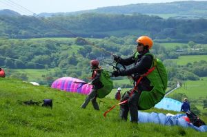 New paraglider pilots undergoing training at Bell Hill, Dorset, England, in 2018
