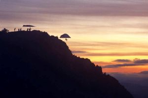 Hang gliders launching at sunset from Grandfather Mountain